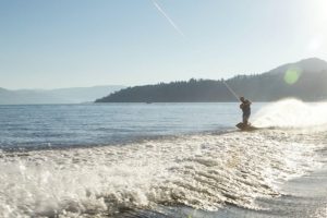 wakeboarder on Okanagan lake enjoying the outdoor summer activities in Kelowna