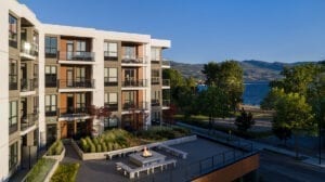 The Shore Kelowna on Okanagan lake, with an outdoor terrace and fireplace for guests to enjoy, shown here on a sunny day in the Okanagan