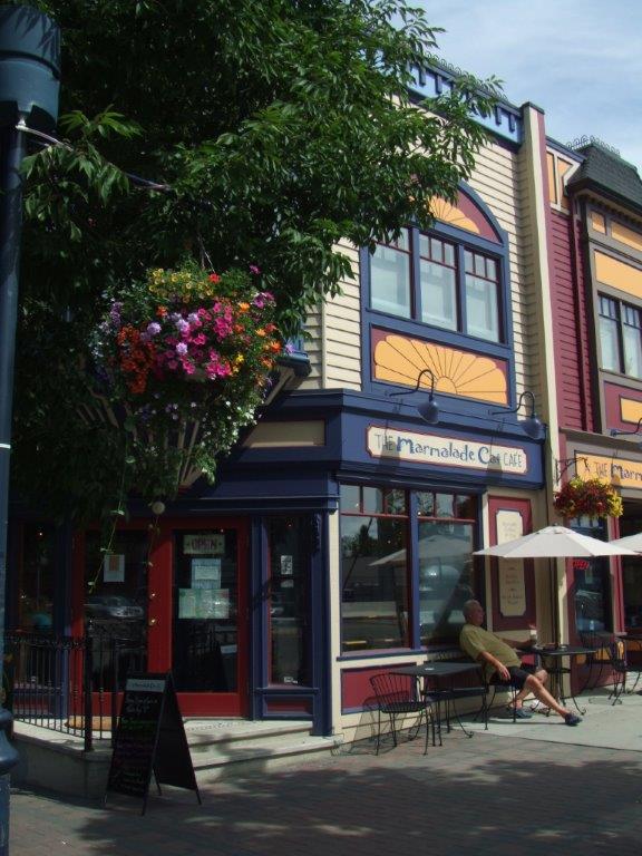 The exterior of the Marmalade Cat Cafe, with navy blue and burgundy trim on a Victorian style building.