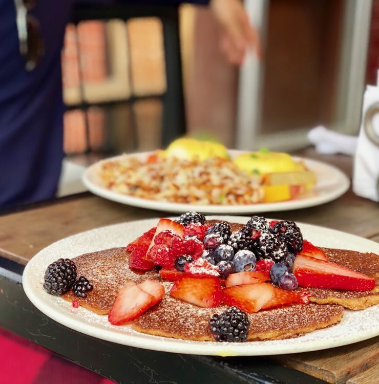 oatmeal blueberry pancakes from the bohemian cafe kelowna with strawberries, raspberries and blueberries