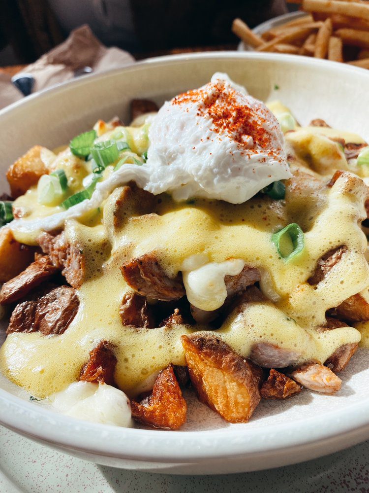 a hashbrown bowl from diner deluxe kelowna with a poached egg on top