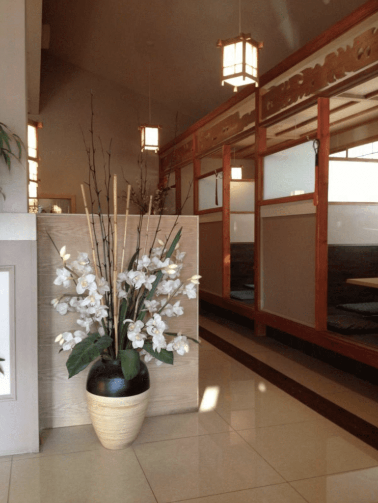 interior of ozeki japanese restaurant with booths and orchid flowers in a vase