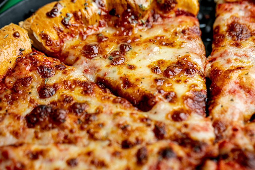 a closeup of cheesy pizza