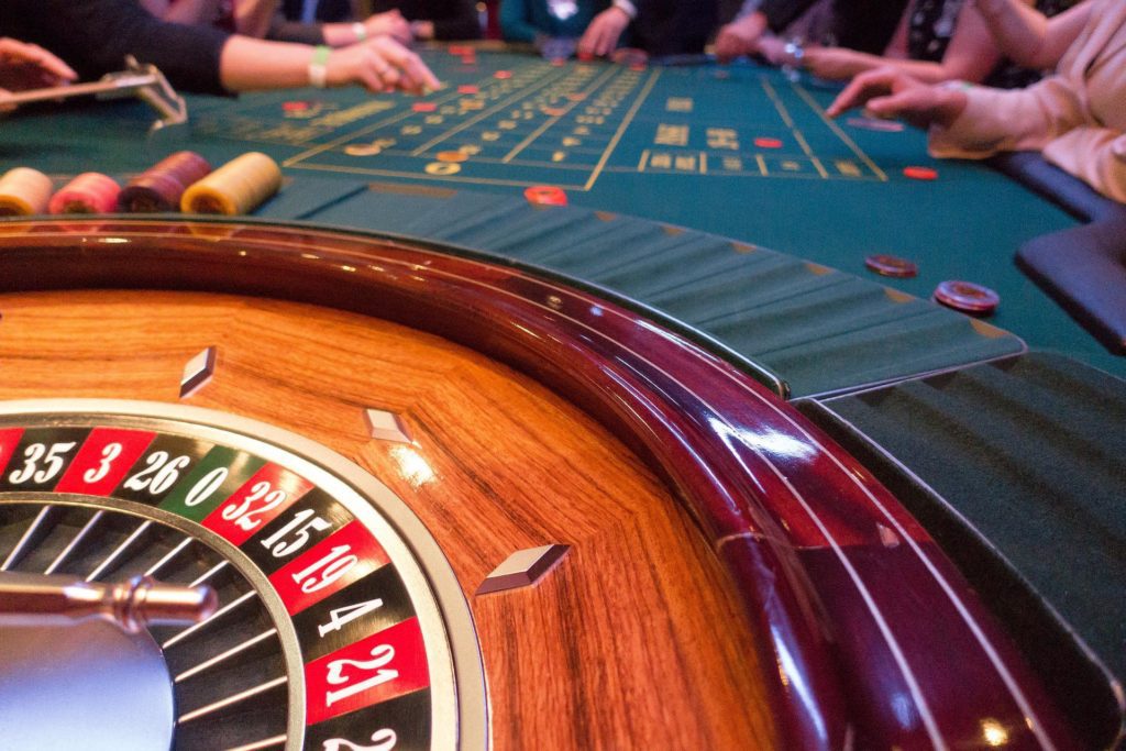 a closeup of a roulette table with chips on green surface
