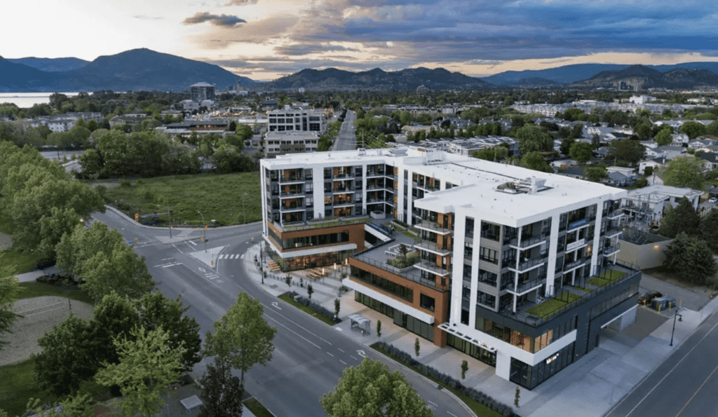 An exterior view of The Shore Kelowna showing Kelowna in the background