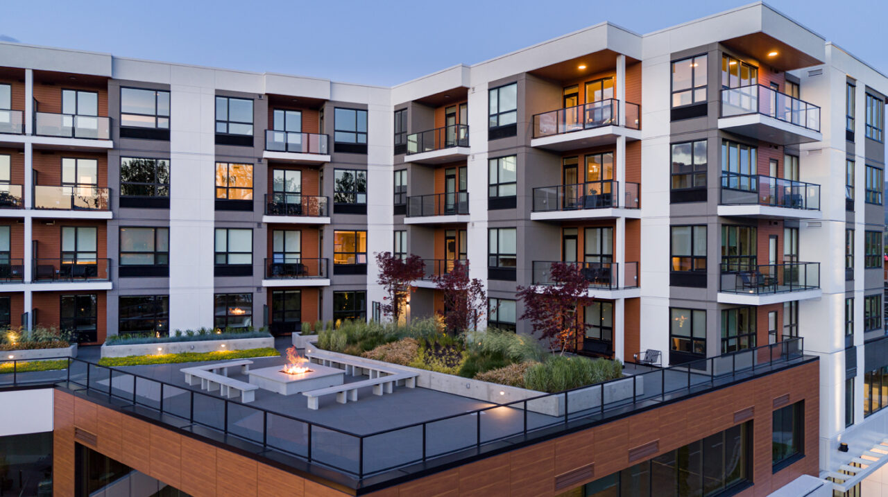 the shore kelowna, an apartment hotel, exterior view showing the outdoor terrace and fire pit