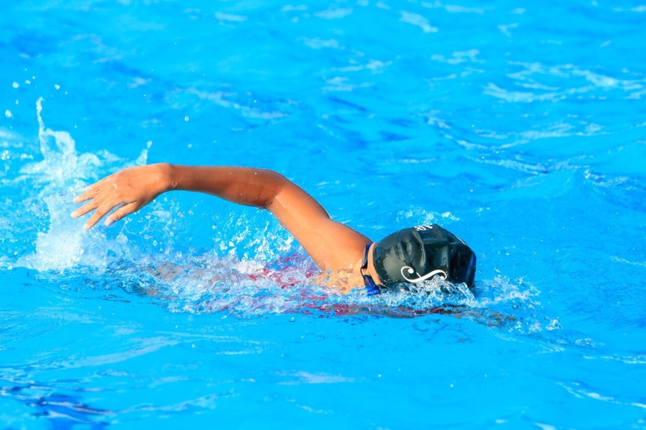 a swimmer in goggles and a swim cap, swimming laps at Parkinson Recreation Centre in Kelowna