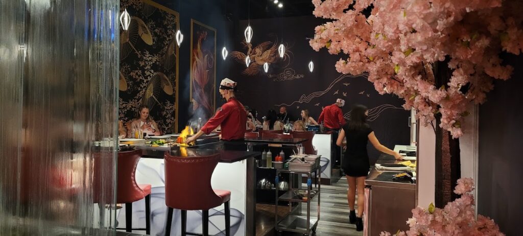 dinner being prepared as part of a show at kasai teppanyaki restaurant in Kelowna, with an artificial cherry blossom tree in the foreground