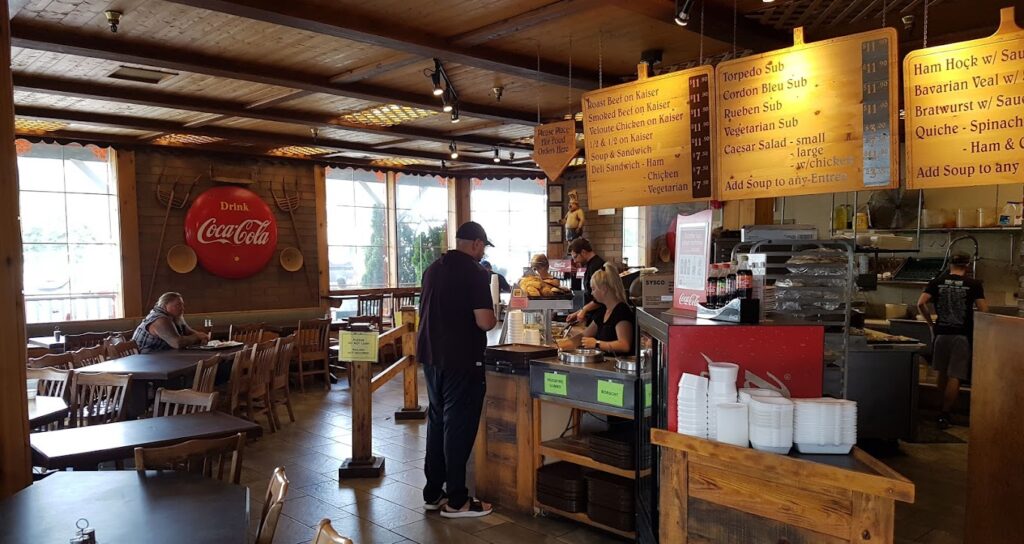 woodfire bakery restaurant interior with menu boards, tables and chairs, and the serving ordering area