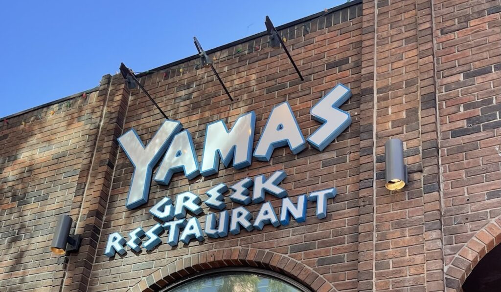 a closeup of the exterior sign of yamas greek restaurant
