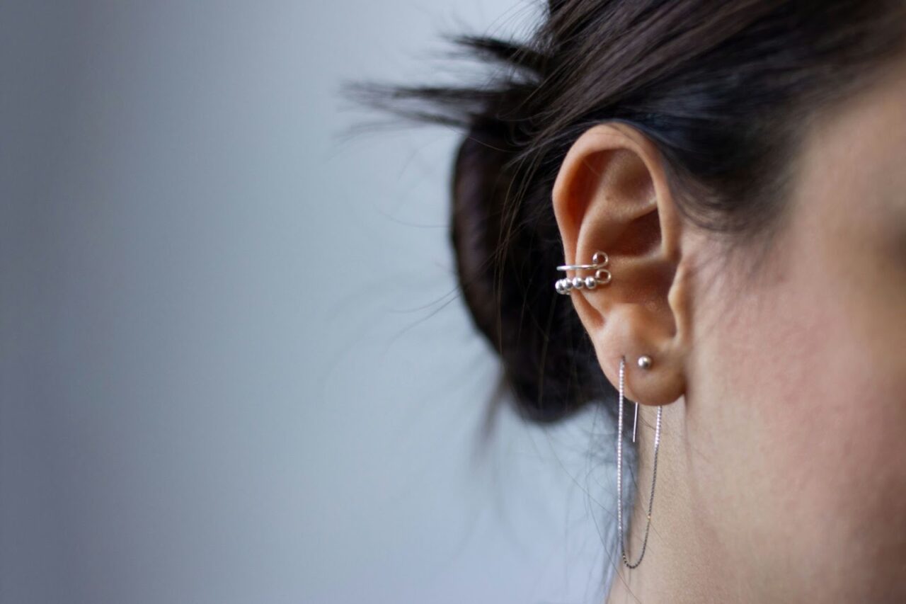 An ear with multiple piercings
