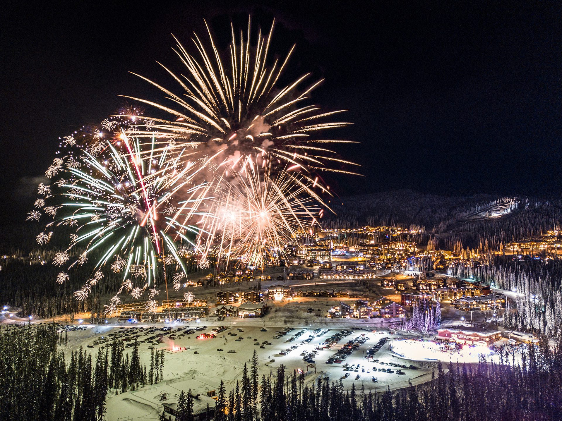 Village view of Big White Ski Resort at night with fireworks in distance